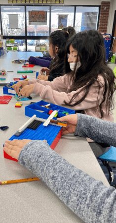 group of kids assembling legos